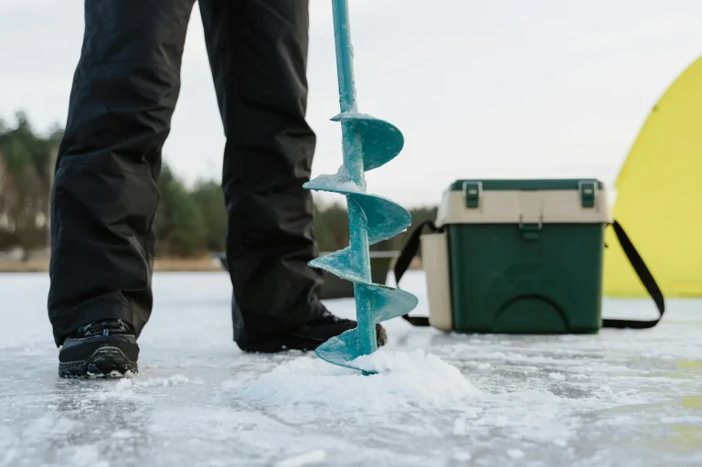 Ice fishing experience in Finnish Lapland on a frozen lake surrounded by Arctic nature